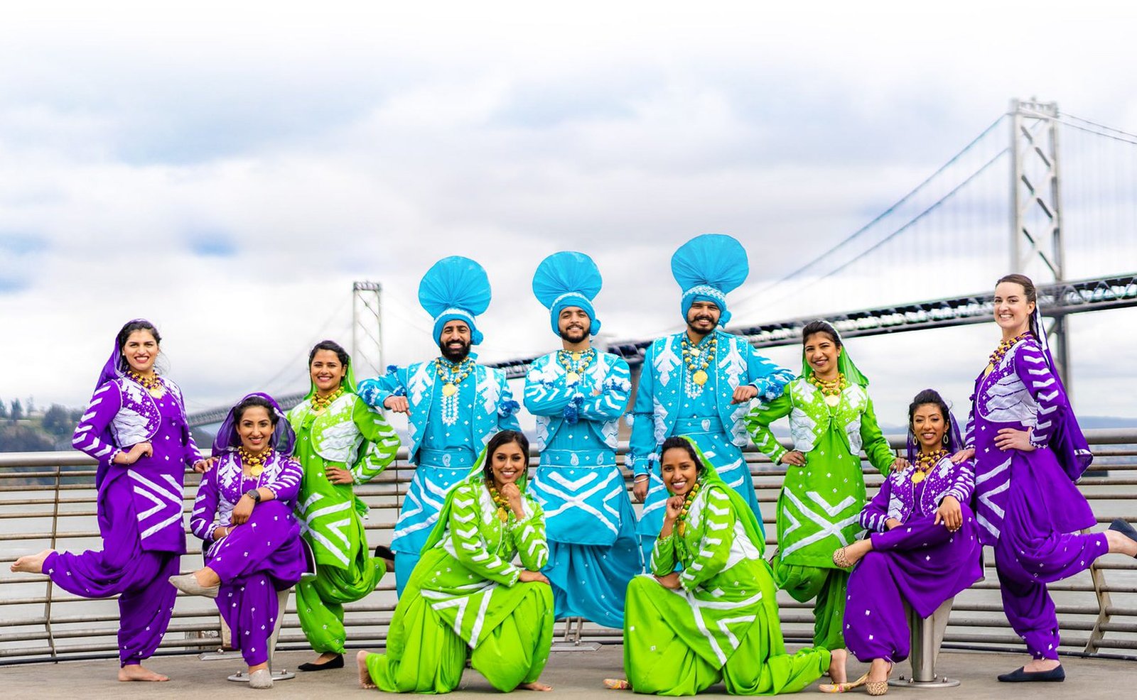 Bhangra Empire dancers in colorful traditional outfits by the Bay Bridge