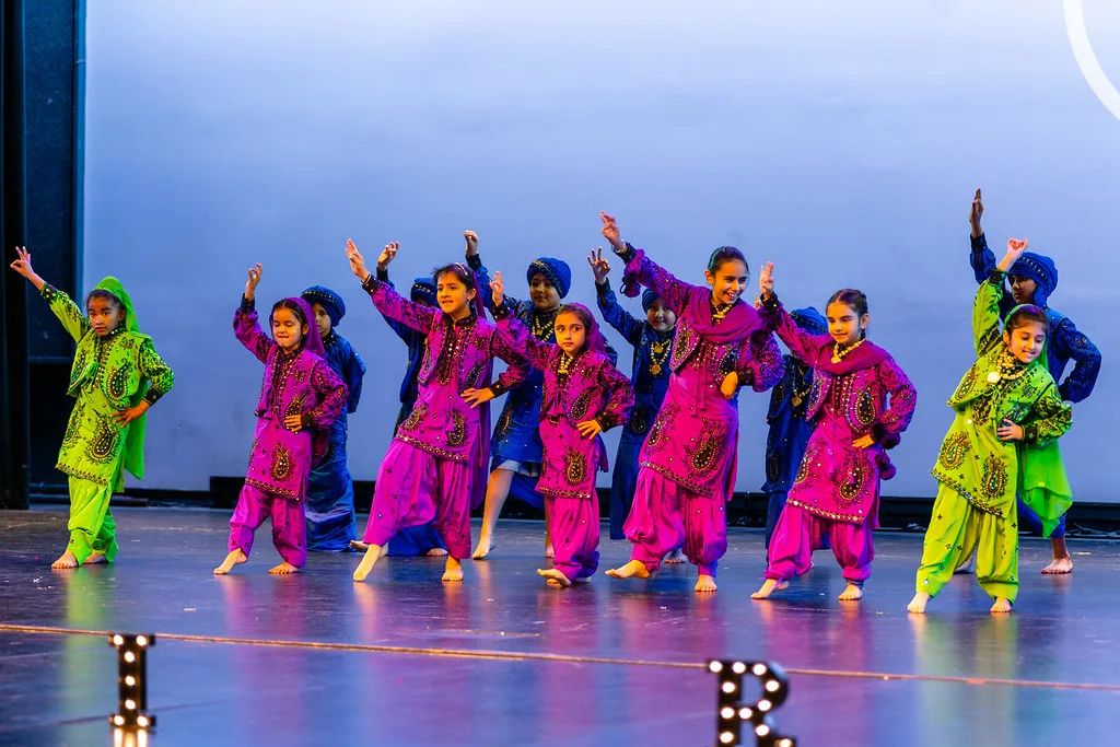 Bhangra Empire youth team performing on stage