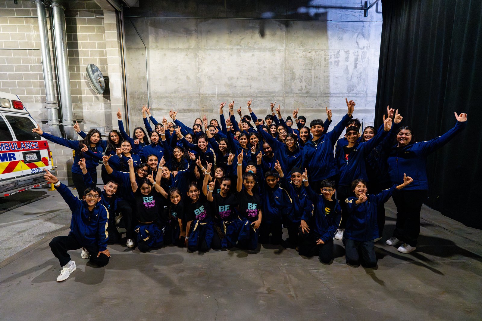 Academy dancers smiling and posing together backstage at Chase Center.